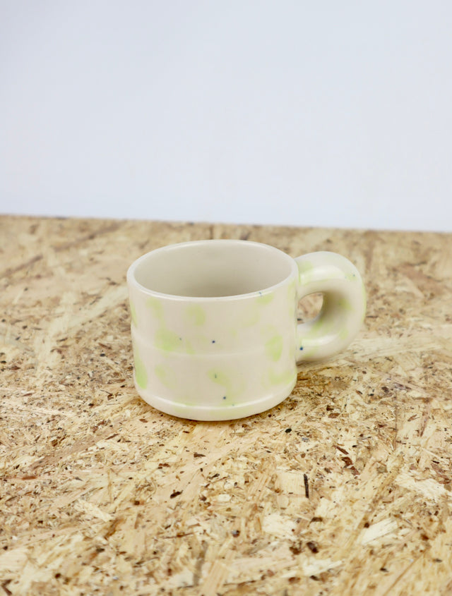 Dialog cup in light green drip with tiny blue dots