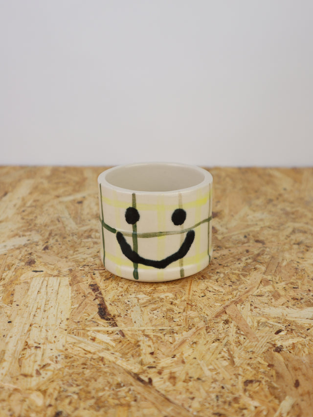 You are funny cup in green & yellow grid