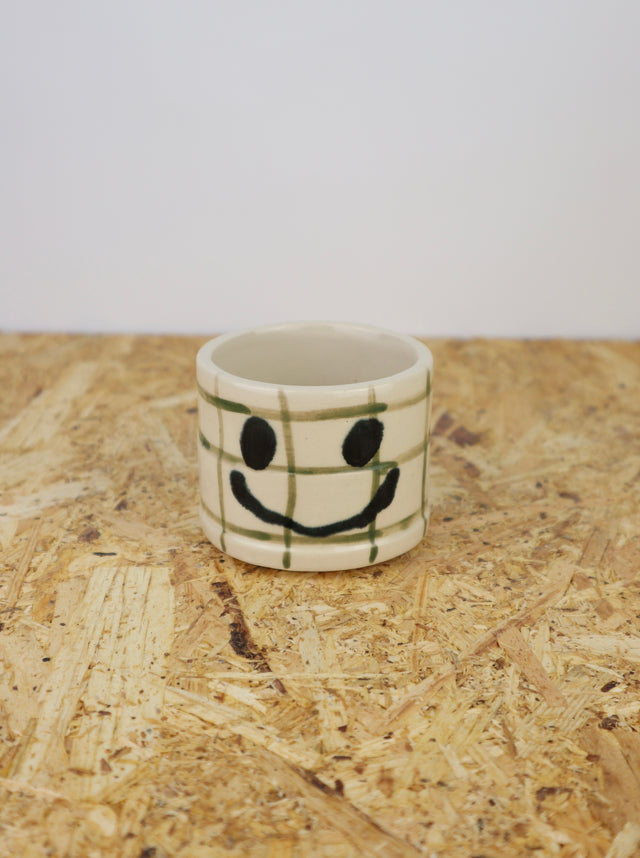You are funny cup in bright green grid