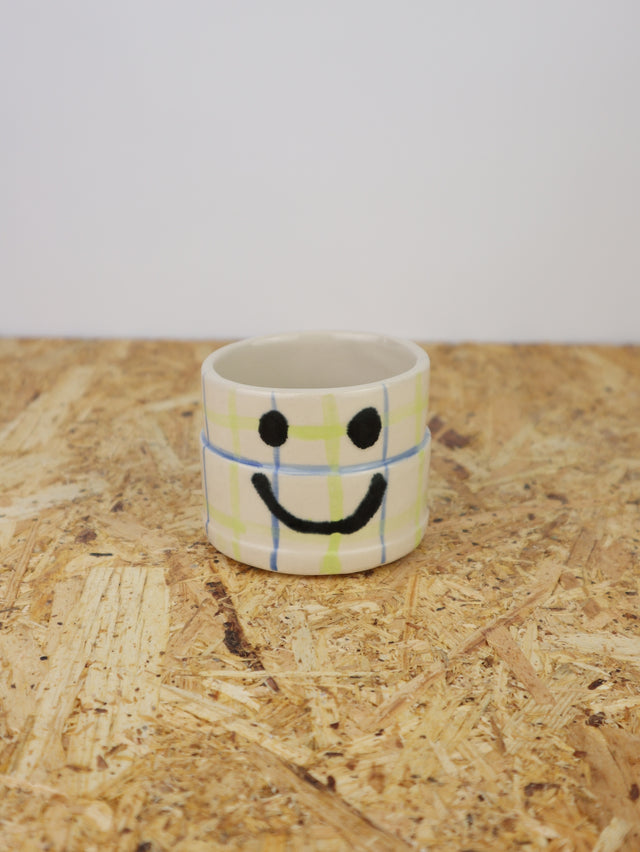You are funny cup in blue & green grid