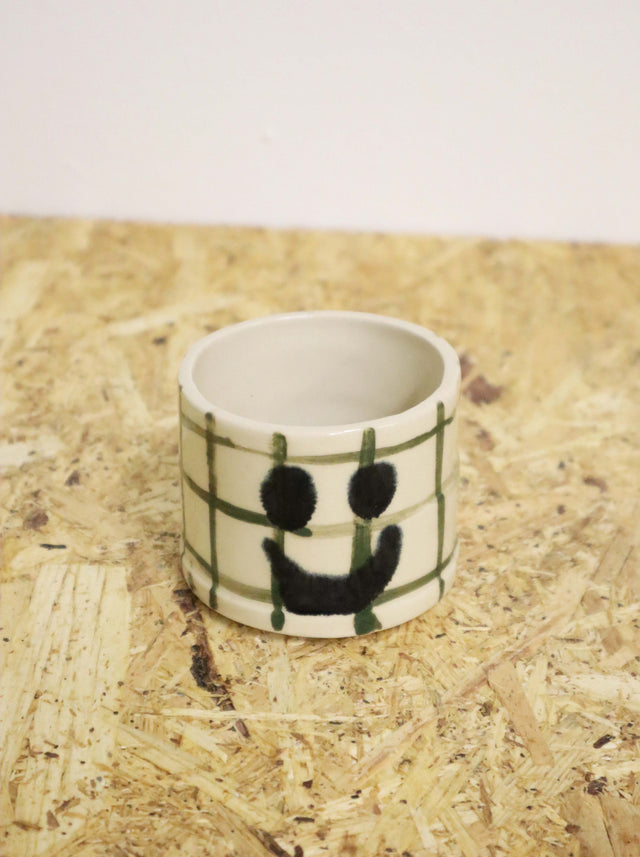 You are funny cup in dark green grid